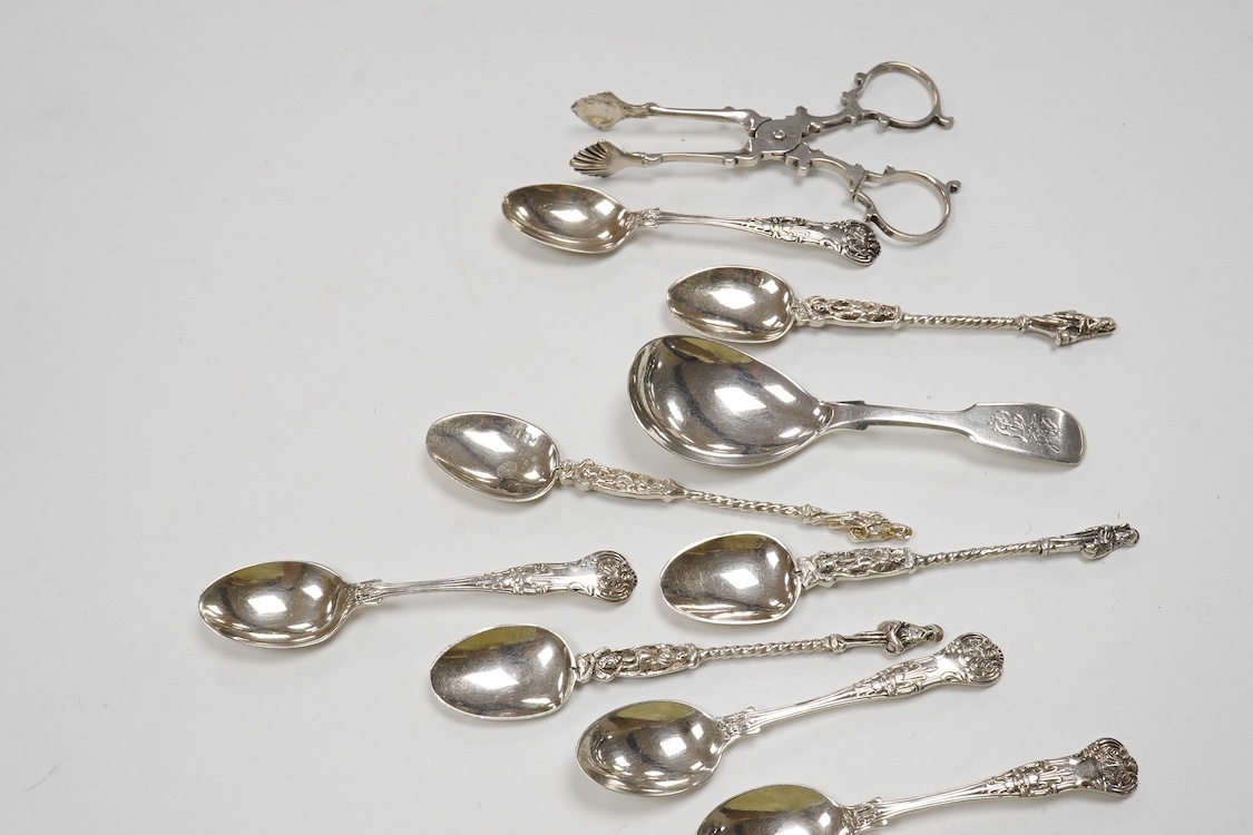 Two 19th century silver caddy spoons including Reid & Sons, Newcastle, 1837, ten assorted silver coffee spoons including apostle and a pair of George V silver sugar nips by William Hutton & Sons, 4.8oz.